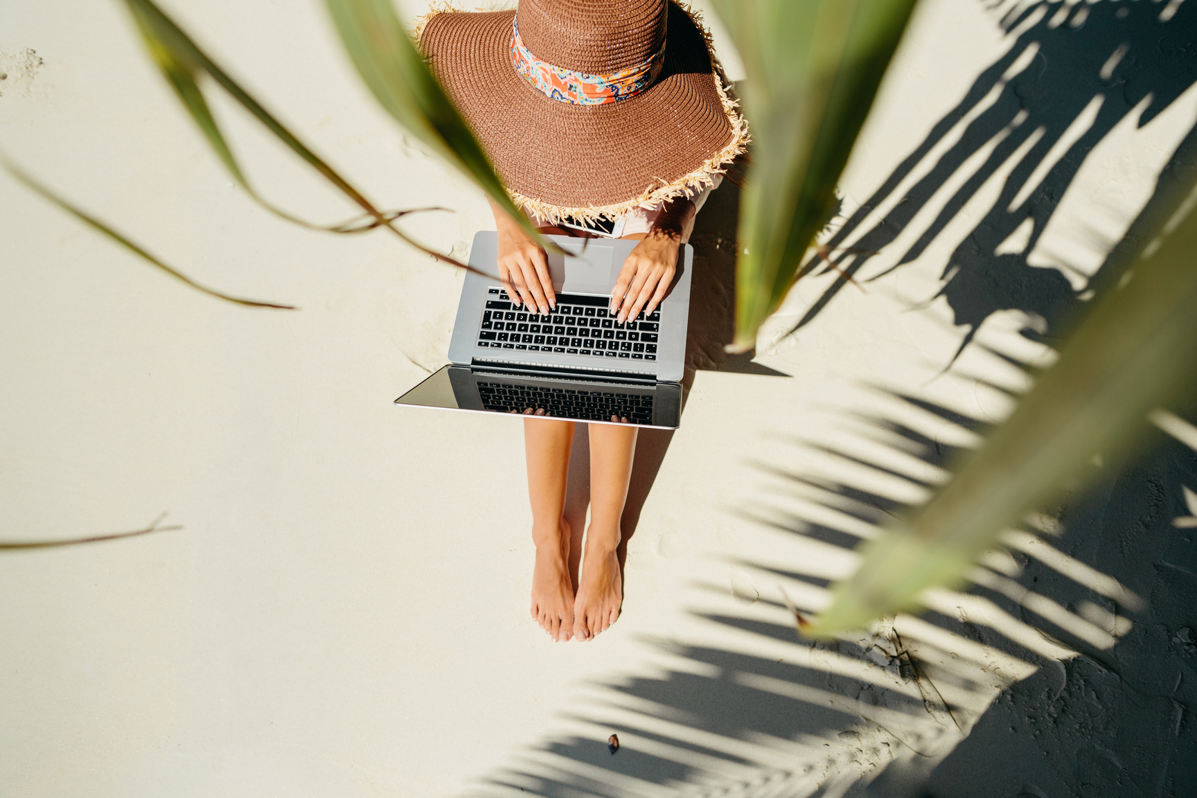 Woman Using Laptop at the Beach